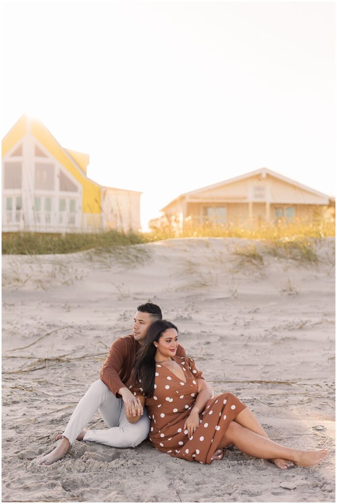 couple sitting on the beach together for their photography session in Saint Augustine Florida