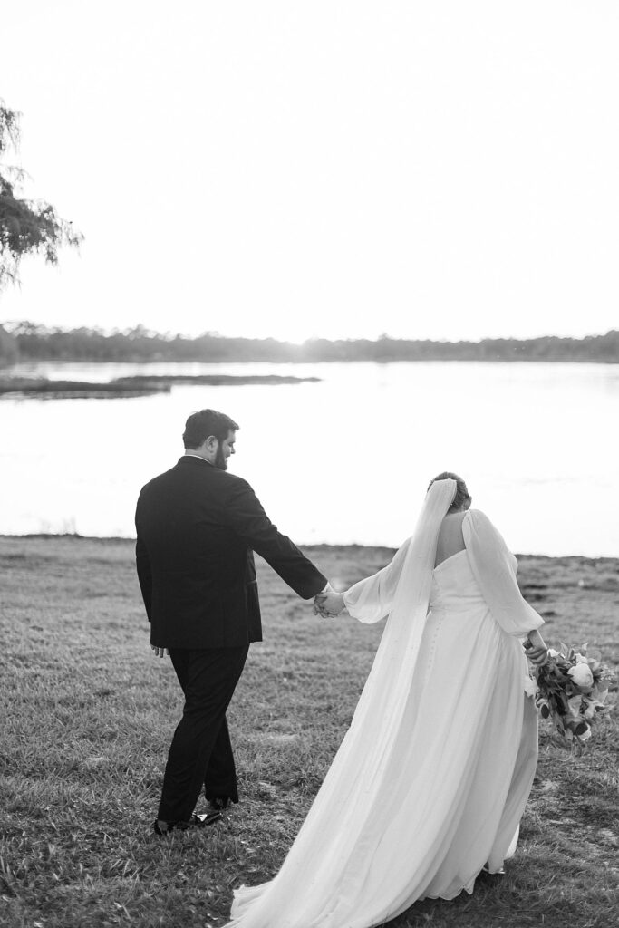 couple walking by the lake at wedding