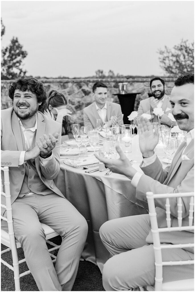 wedding guests laughing during speeches and toasts