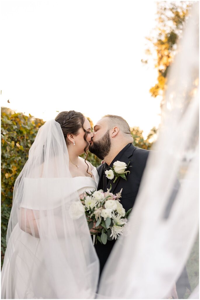 Bride and Groom sharing kiss at ever after farms wedding venue