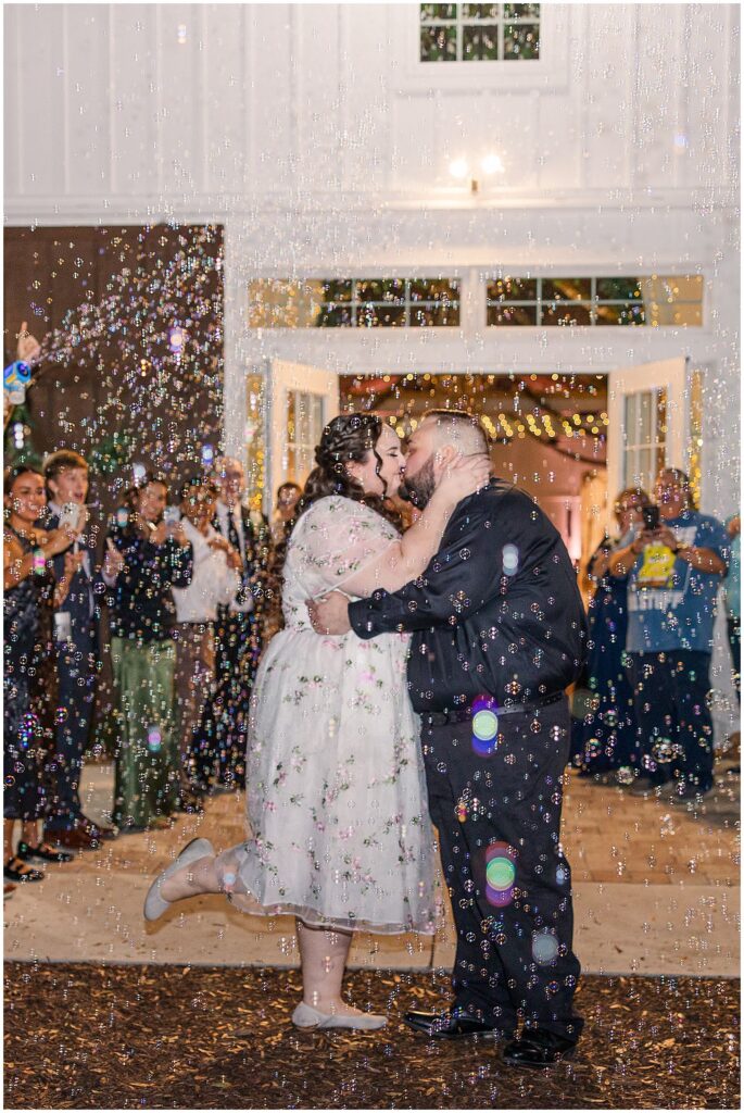 Bride and Groom kissing during bubble exit at Ever After Farms Vineyard Wedding
