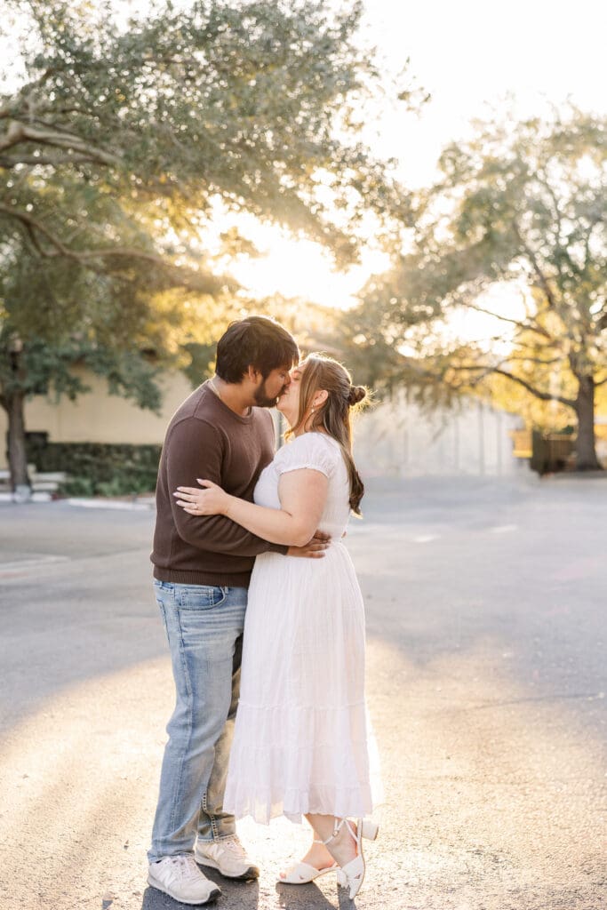 couple kissing at sunset engagement session captured by orlando wedding photographer blak marie photography
